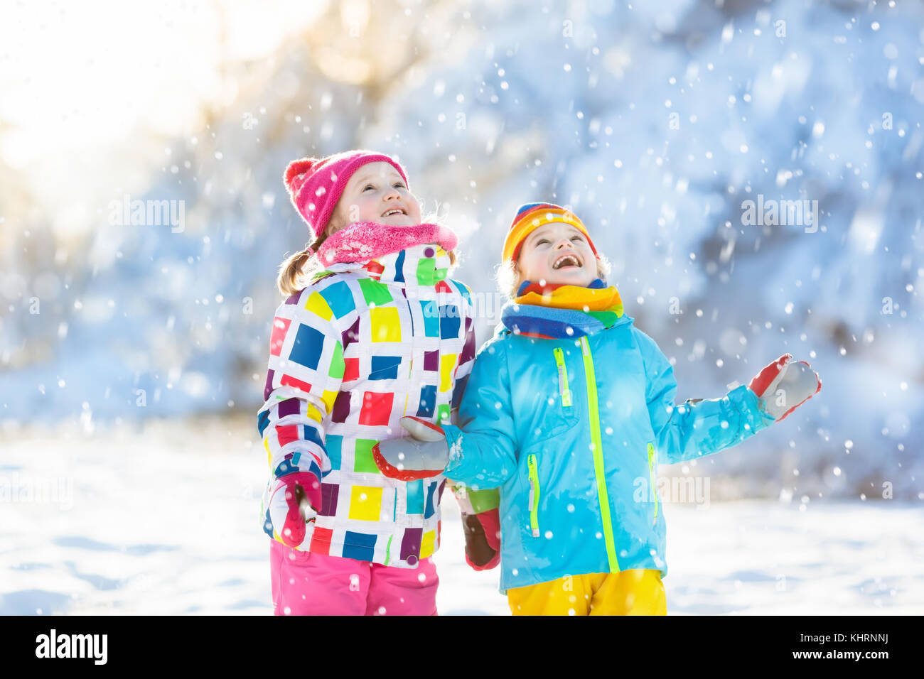 Kids Playing In Snow Children Play Outdoors On Snowy Winter Day Boy And Girl Catching Snowflakes In Snowfall Storm Brother And Sister Throwing Snow Stock Photo Alamy