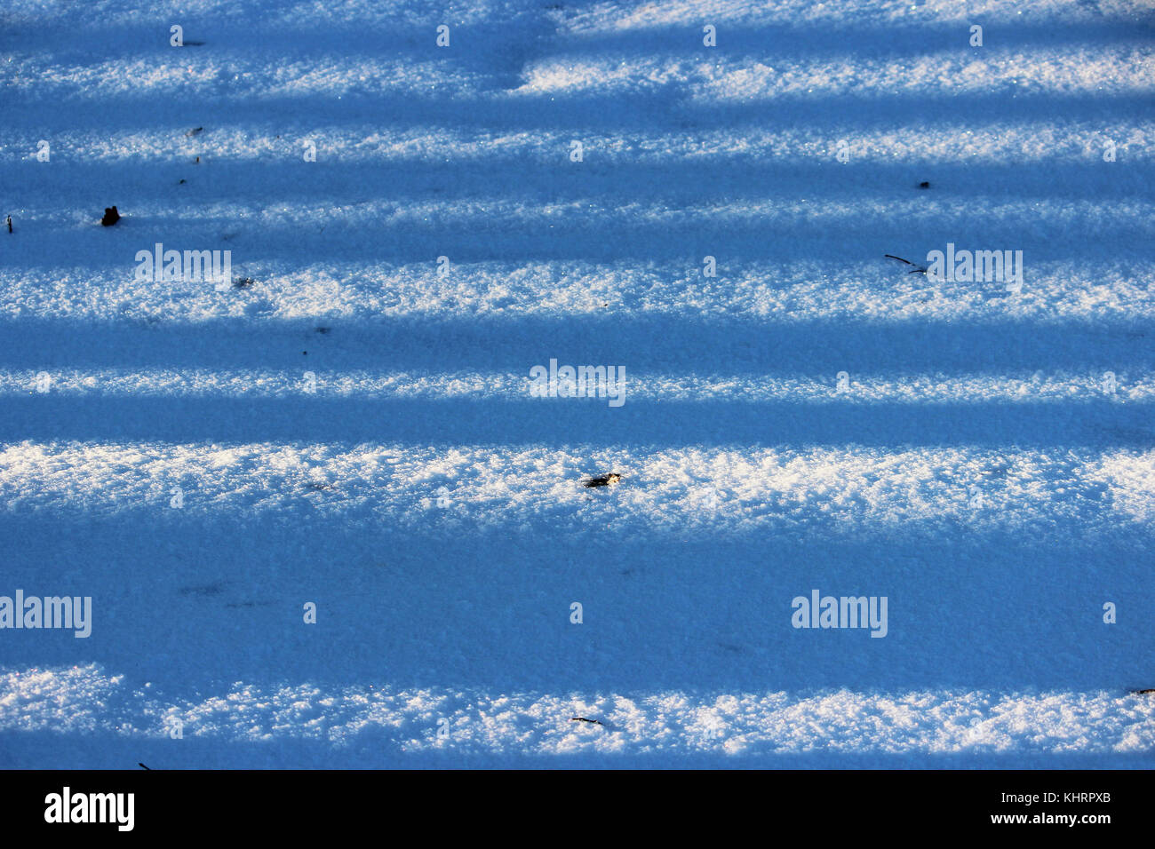 background of fresh white snow winter outdoor with stripes of shadows ...