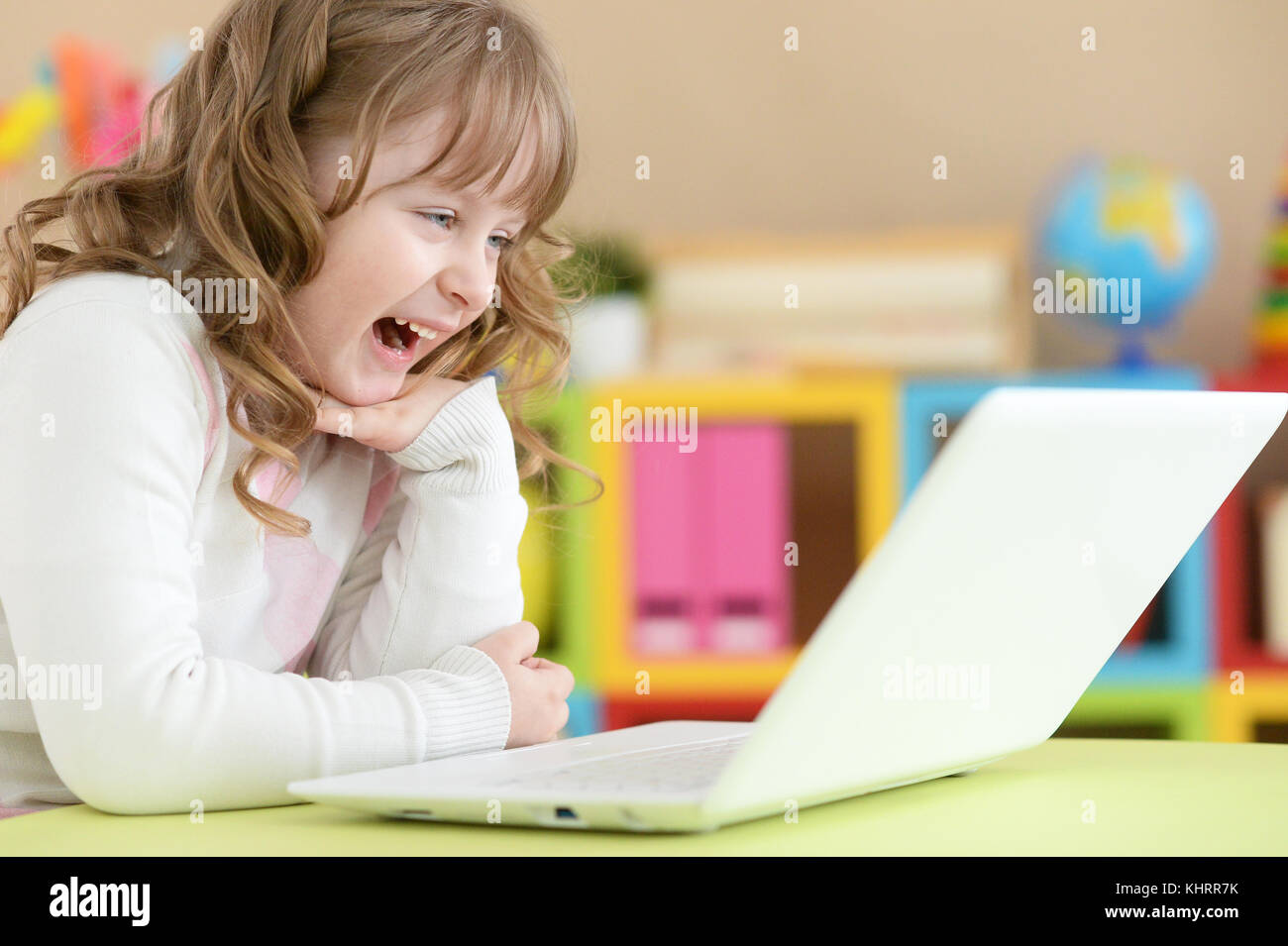 Portrait of a cute girl using laptop Stock Photo - Alamy