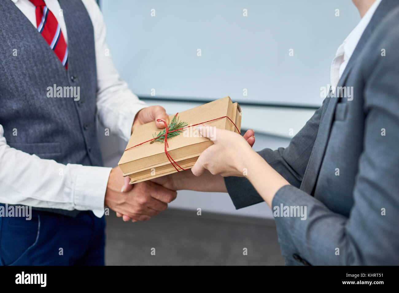 Close up view of unrecognizable businessman shaking hands with female