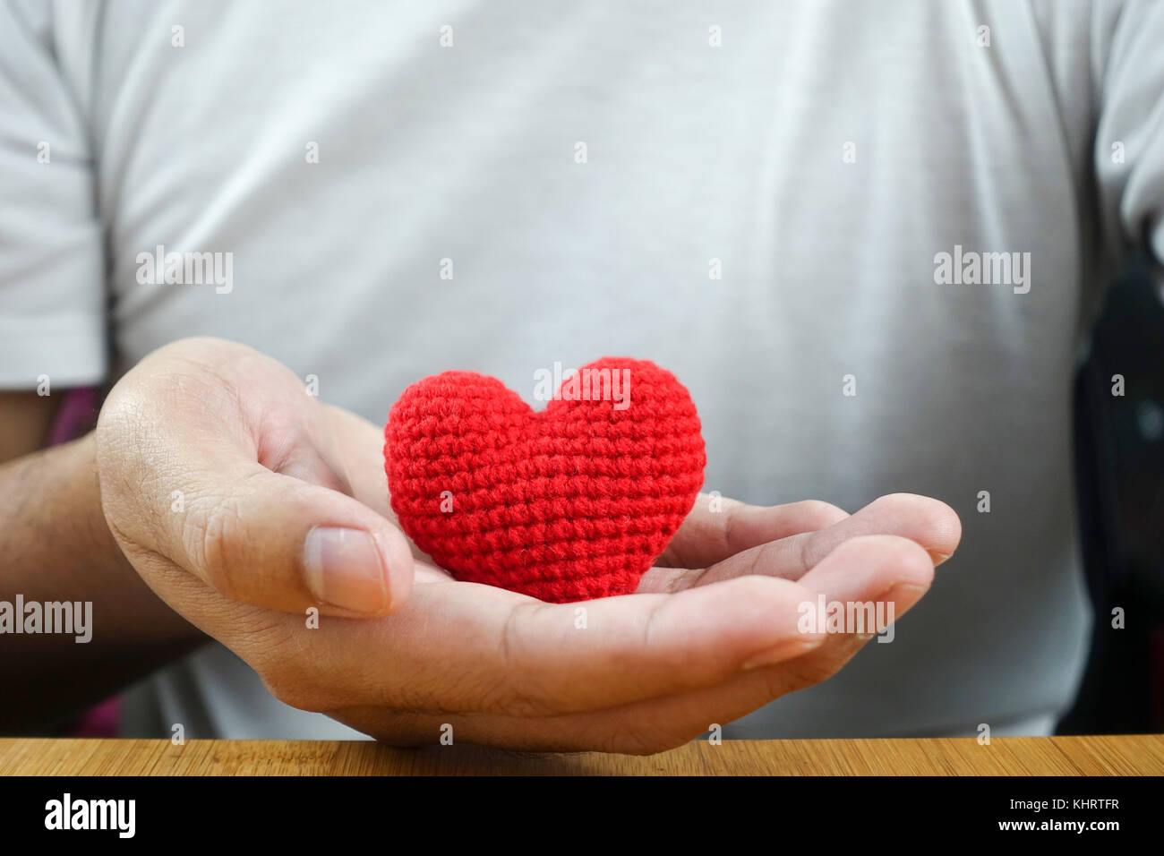 man hand holding red heart - closeup Stock Photo - Alamy