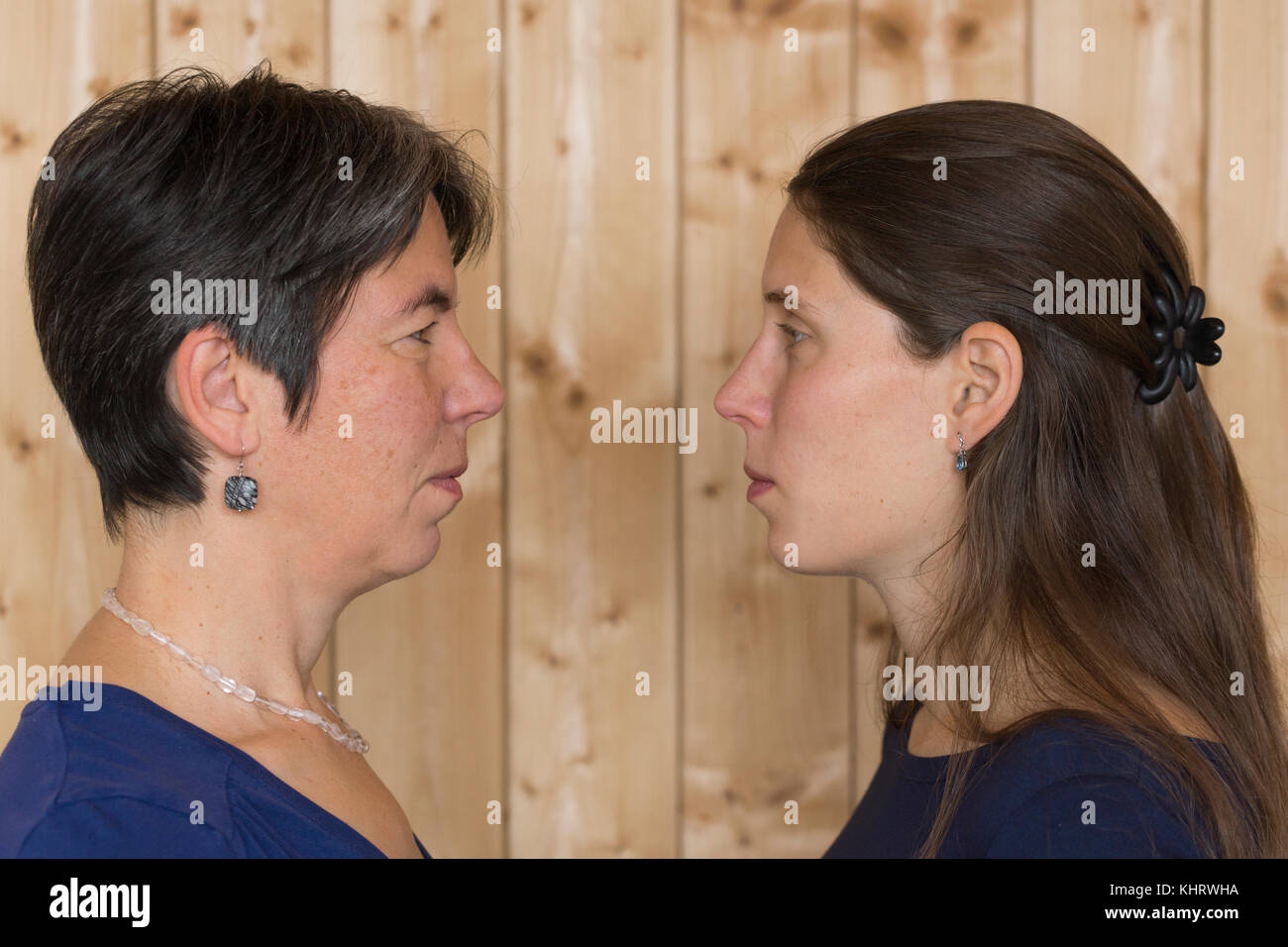 A mother and daughter staring and angry with each other Stock Photo