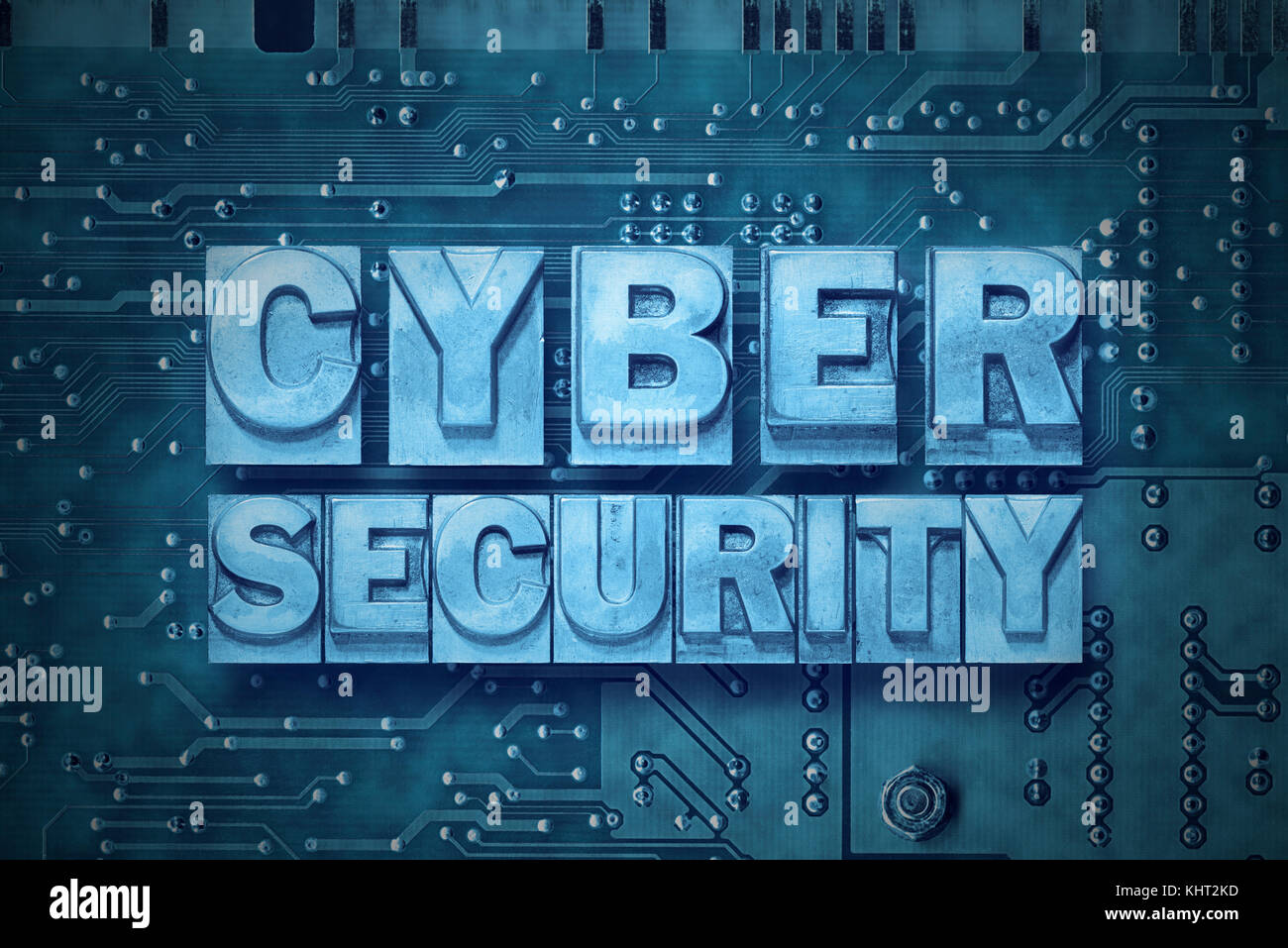 cyber security phrase made from metallic letterpress blocks on the pc board background Stock Photo