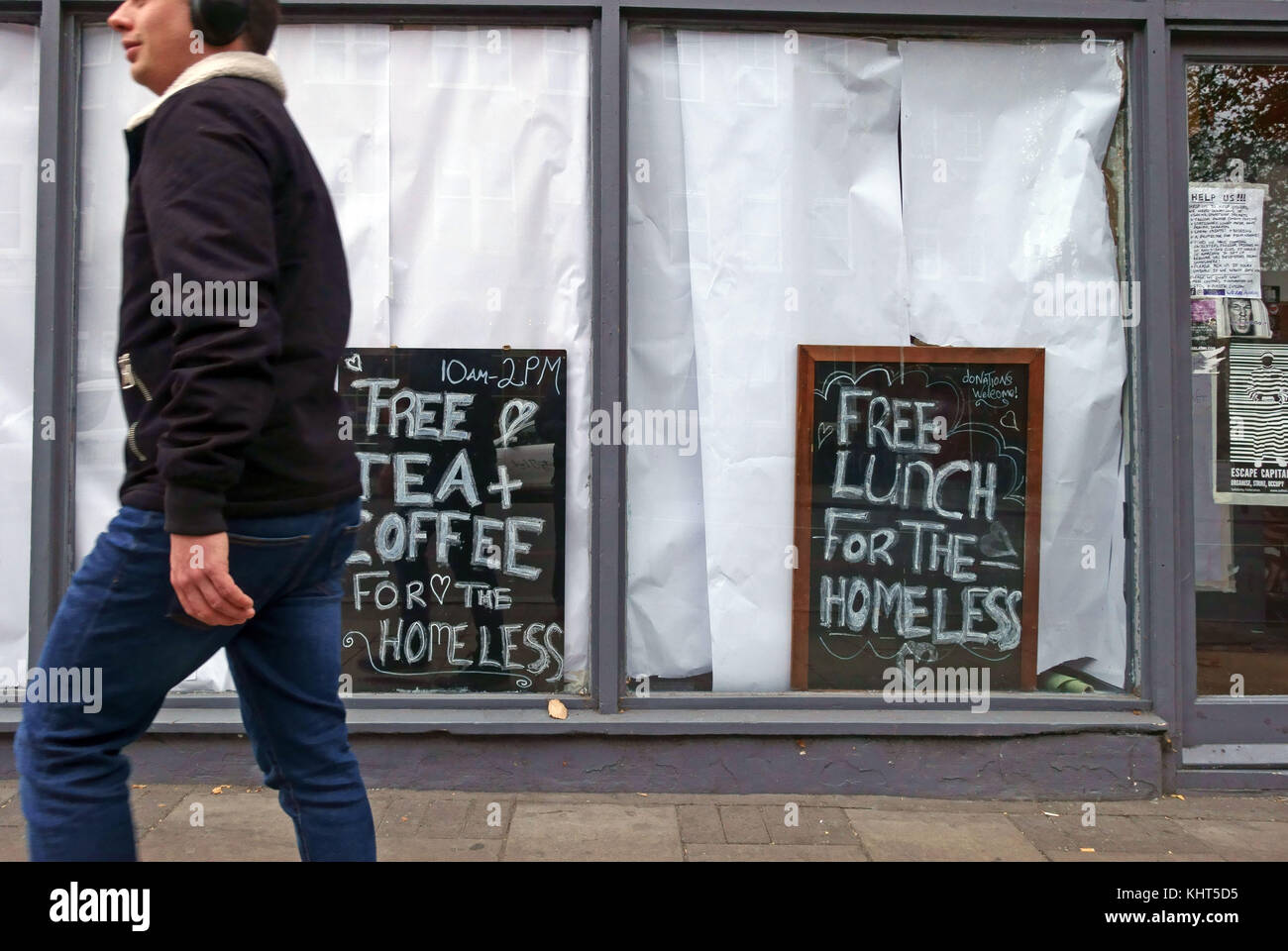 Free lunch and drinks offered to homeless people by squatters occupying a closed restaurant in Islington, London Stock Photo