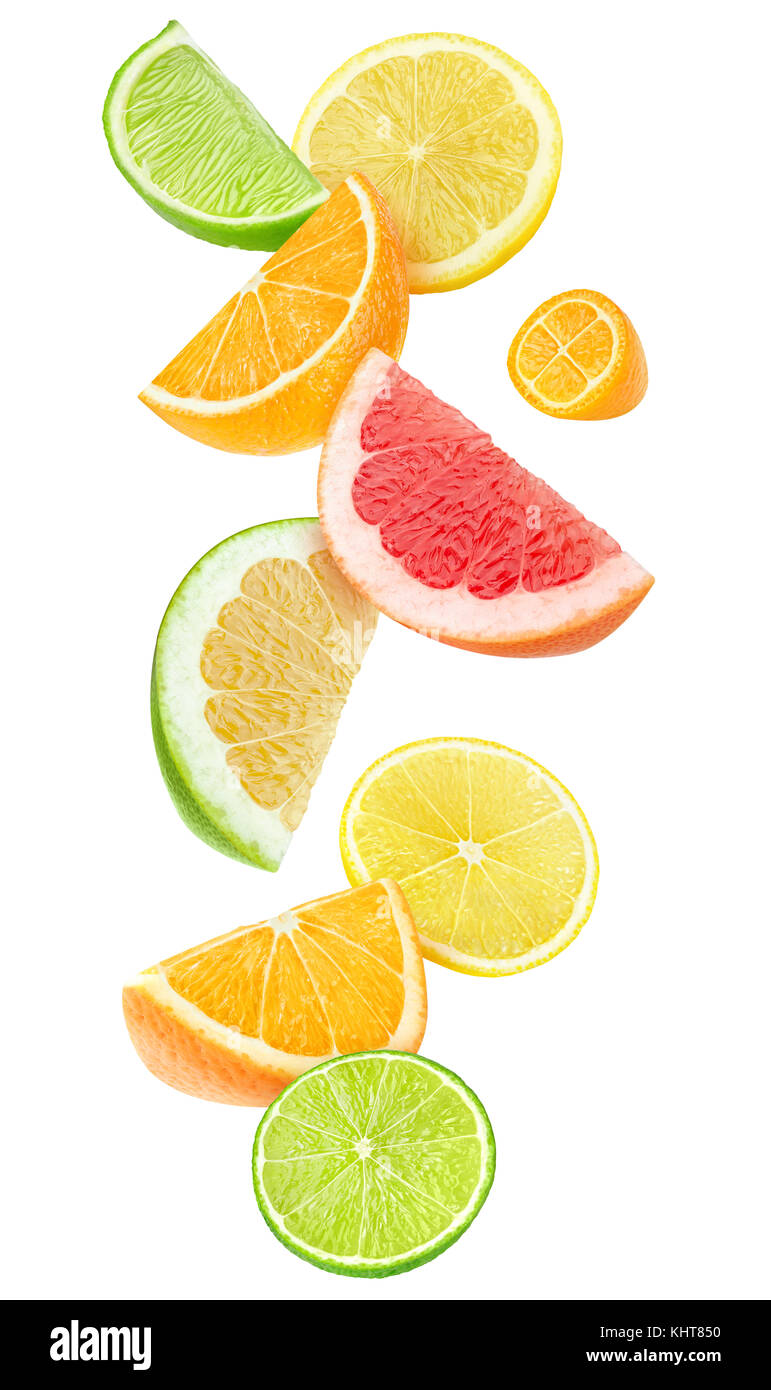 Isolated citrus fruits pieces in the air. Sliced orange, lemon, lime, grapefruit and kumquat falling isolated on white background with clipping path Stock Photo