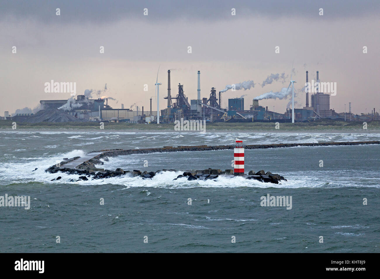industrial area and lighthouse at the harbour entrance, Ijmuiden, Netherlands Stock Photo
