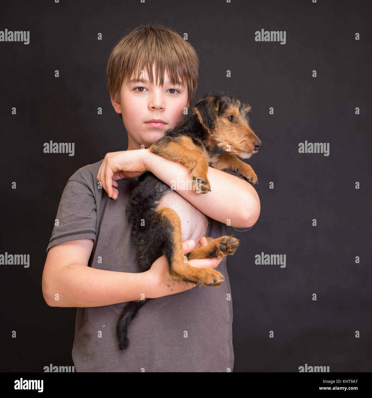 Happy boy portrait, boy and dog in love. Friends having fun whilst posing. Young little cute adorable kid and his puppy, obstreperous scamps. Poses. Stock Photo