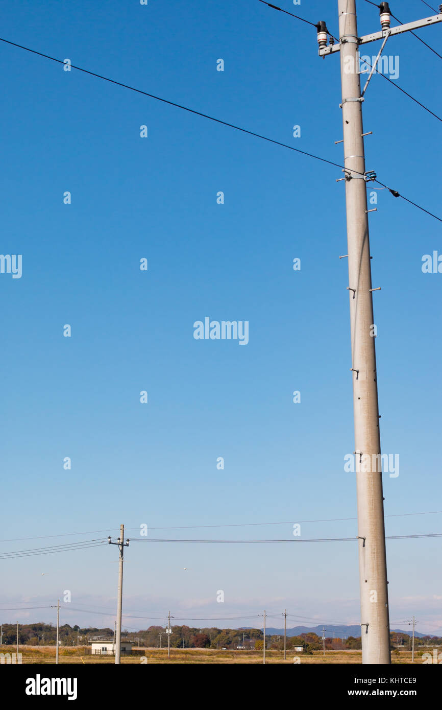 Utility poles and power lines in the Japanese countryside Stock Photo