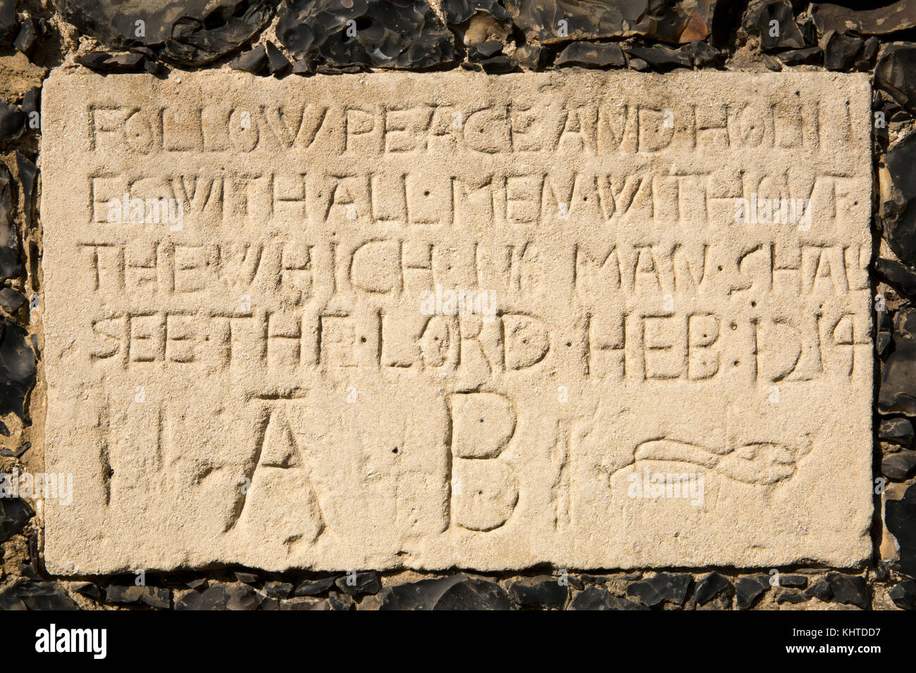 UK, England, Norfolk, Thetford, Old Bury Road, 1610 Richard Fulmerston Almshouses, biblical quote stone, Hebrews 12:14 Stock Photo