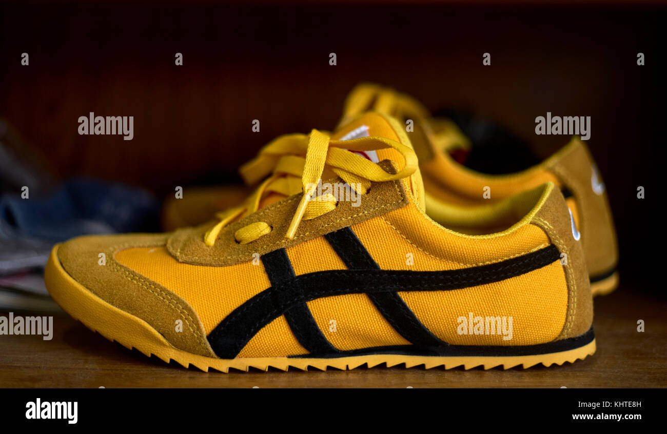 Yellow sports shoes, casual footwear, trainers, sneakers Stock Photo