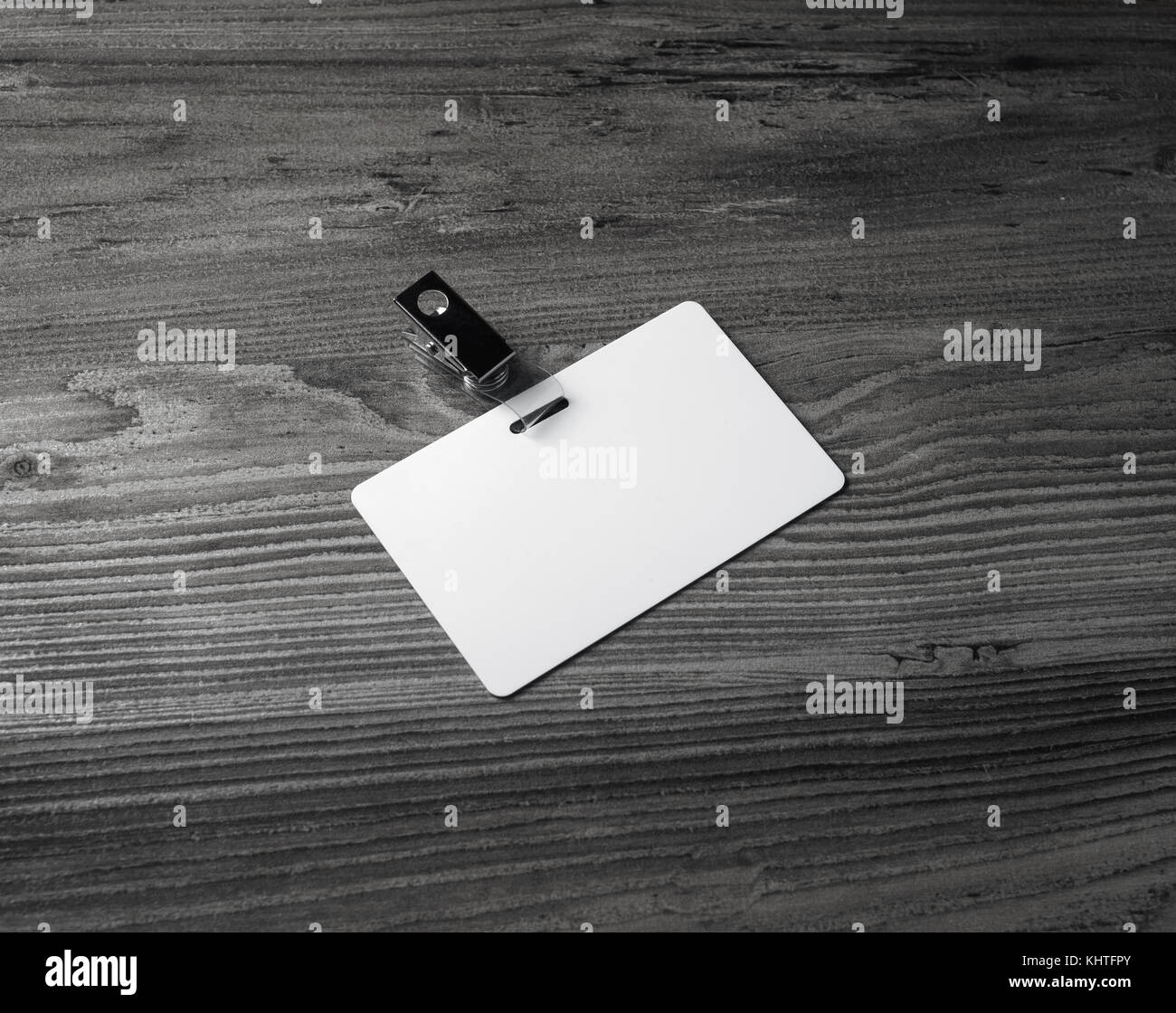 Blank white badge on wood background. Plastic id card Stock Photo - Alamy