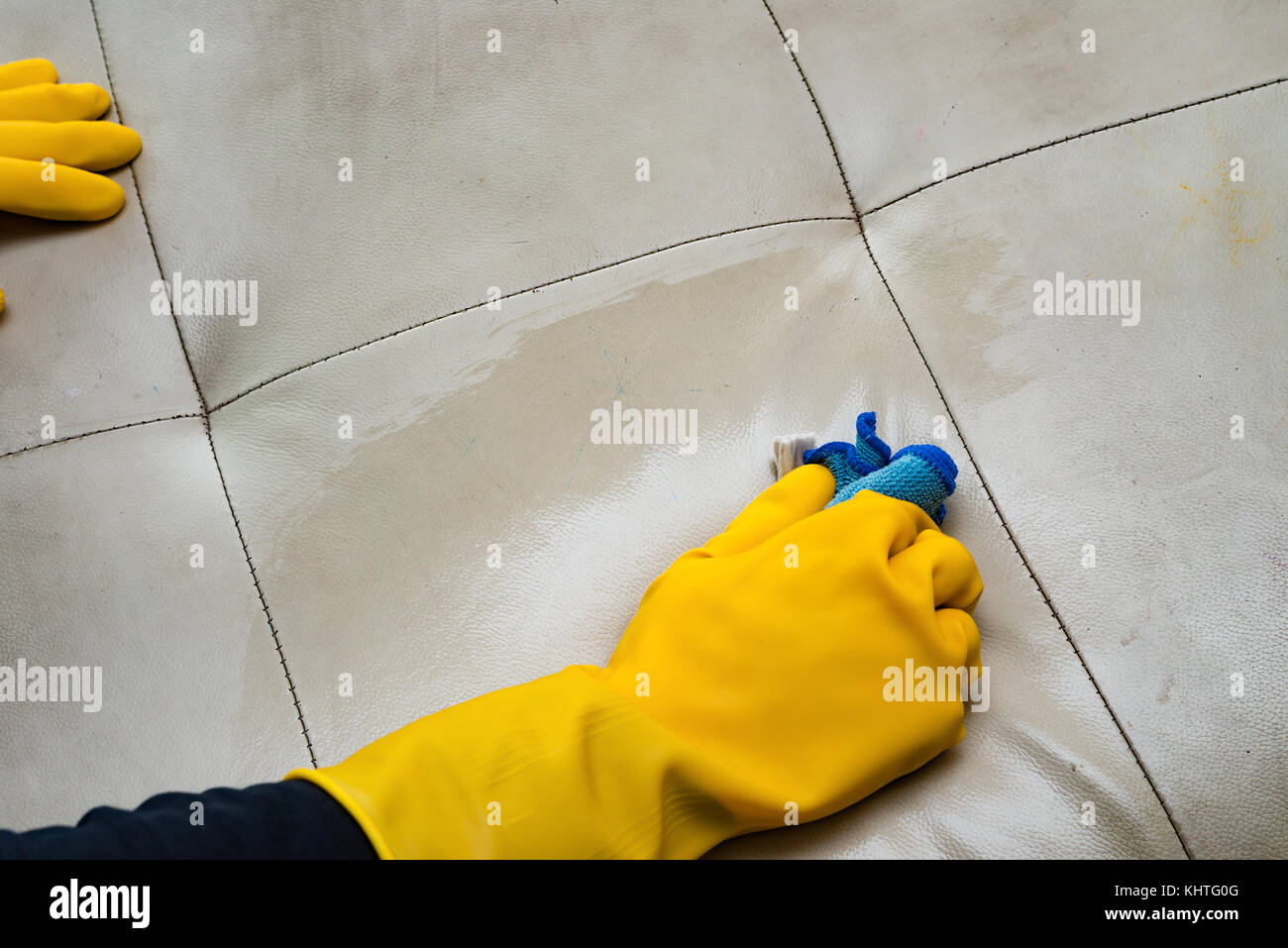 cleaning leather sofa at home with wet towel Stock Photo Alamy