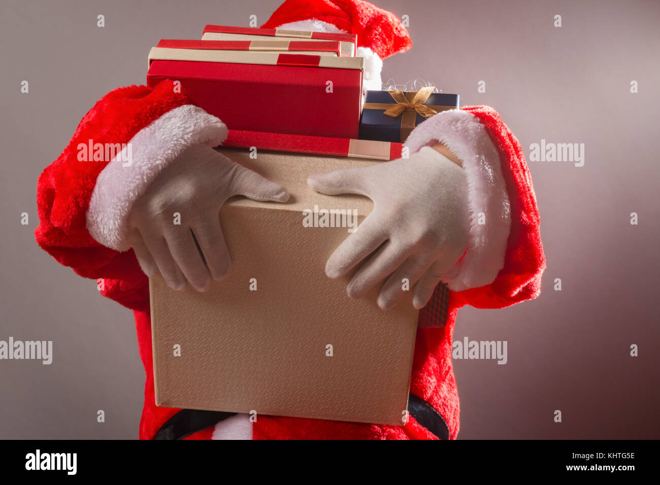 Santa Claus holding lots of gift boxes Stock Photo - Alamy
