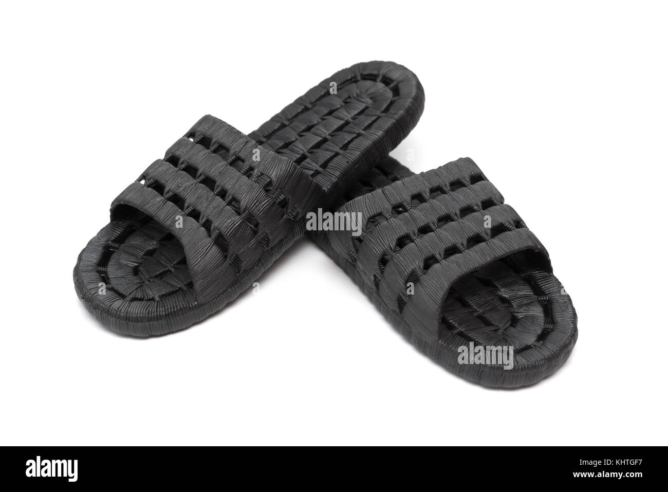 pair of black plastic slippers on white background Stock Photo