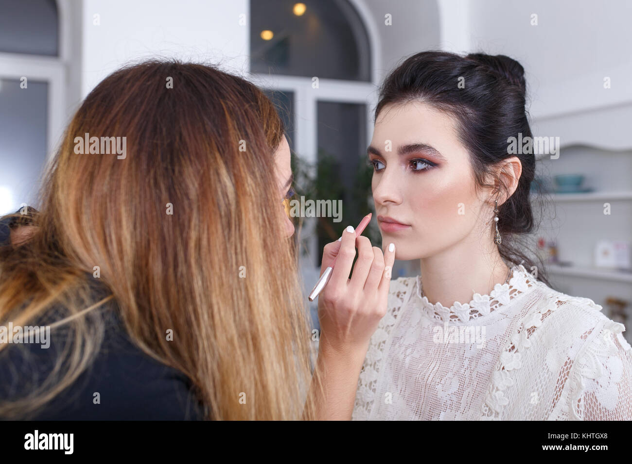 makeup artist applying lip contour with pencil Stock Photo Alamy