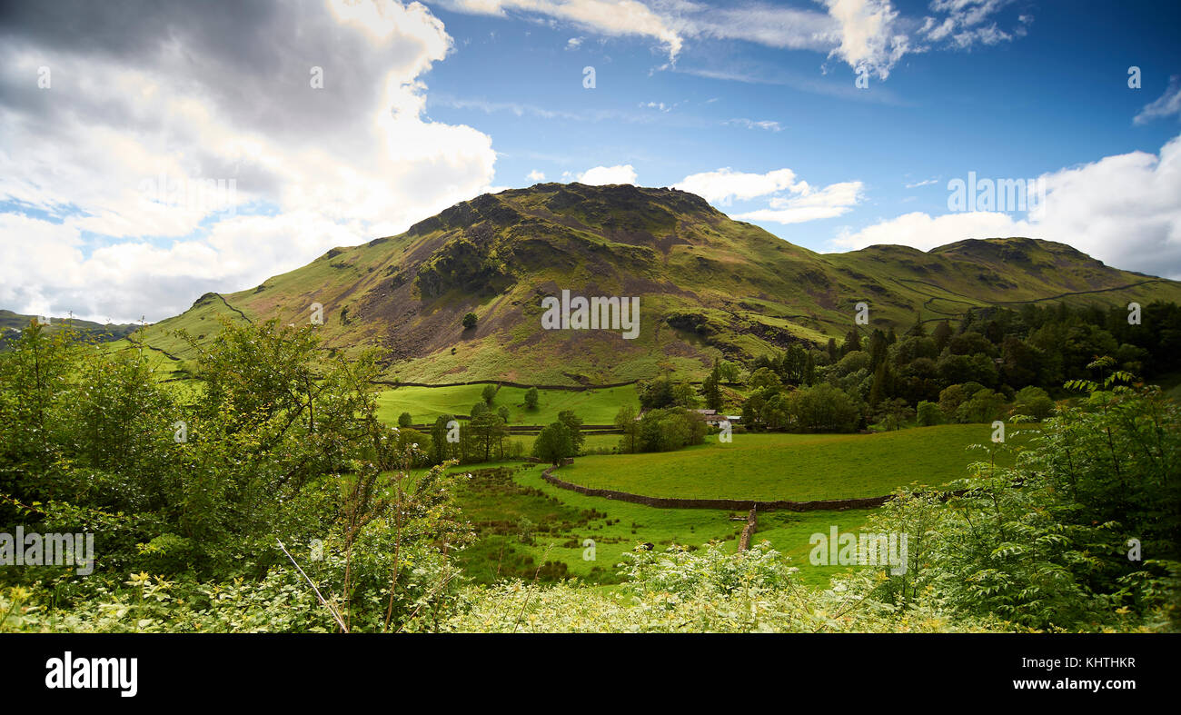Scenic landscape with valley farmhouse below Howgill Fells, Lake District, Cumbria, UK Stock Photo