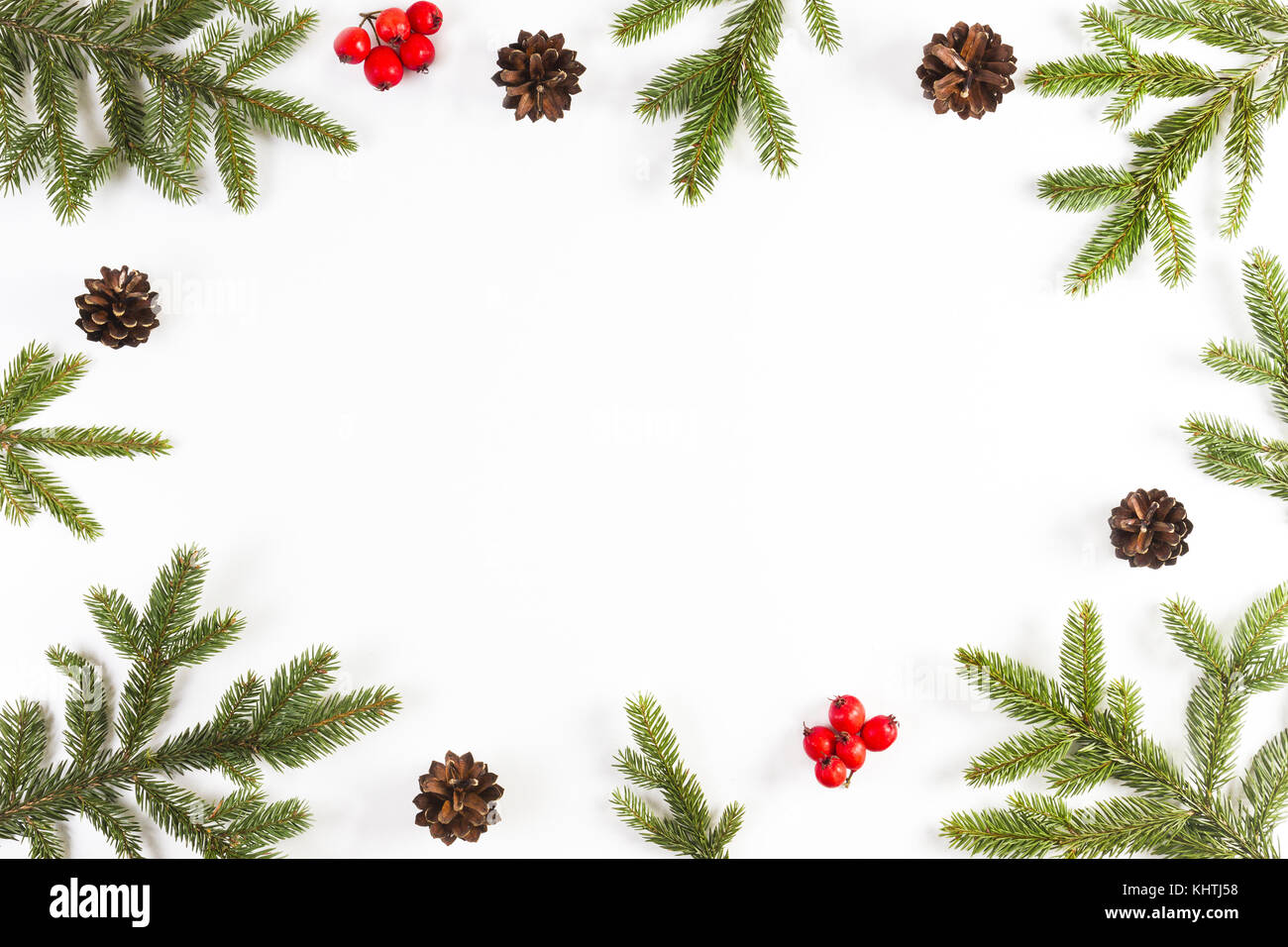 Christmas background with fir branches, pine cones and red berries on ...