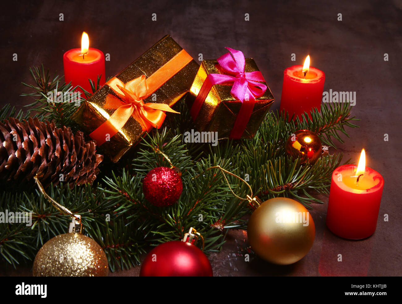 christmas decoration with gift boxes, red candles, christmas tree and