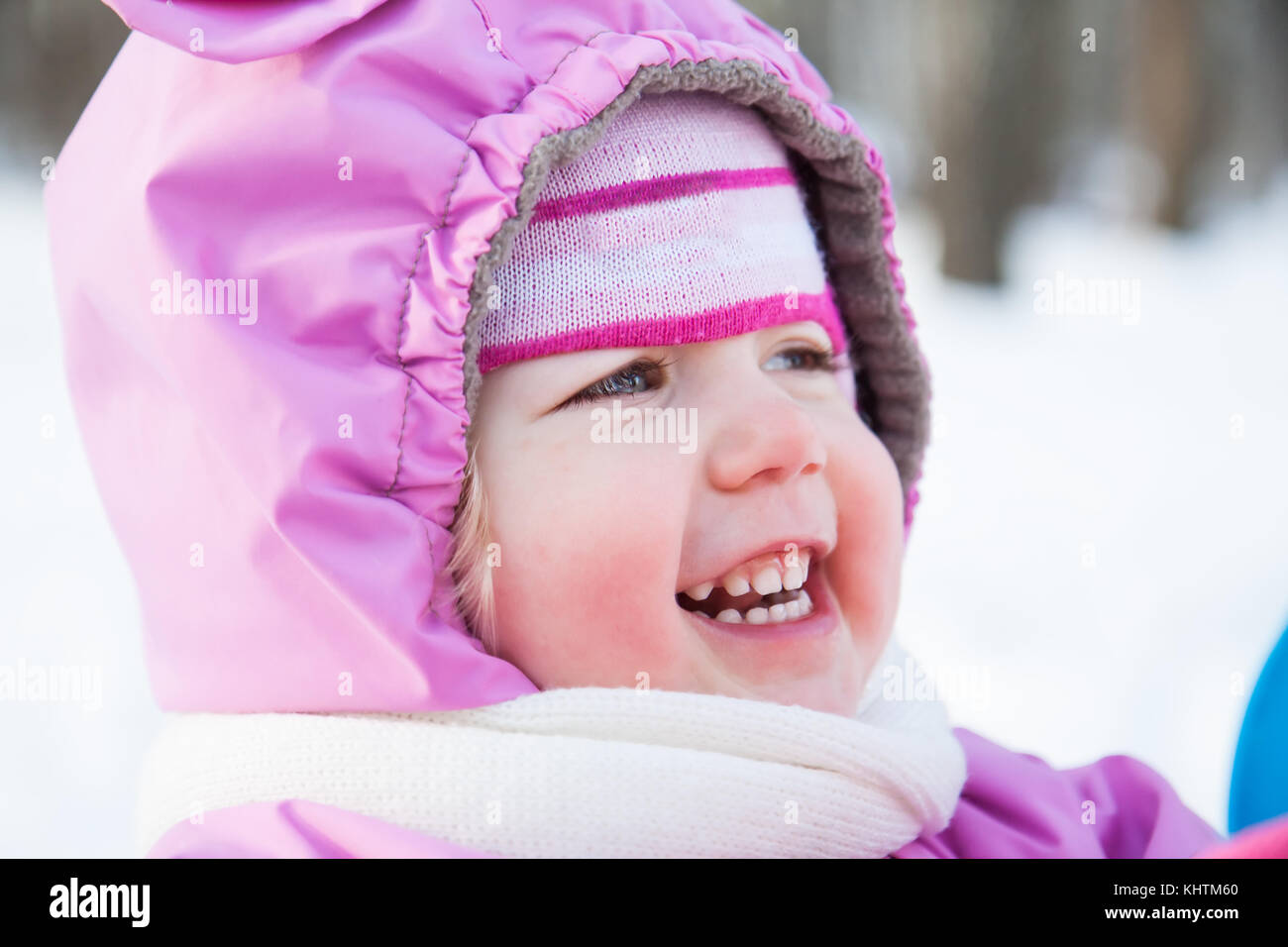 Cold Winter Baby Cute smiling baby portrait in warm clothes in cold sunny winter day ...