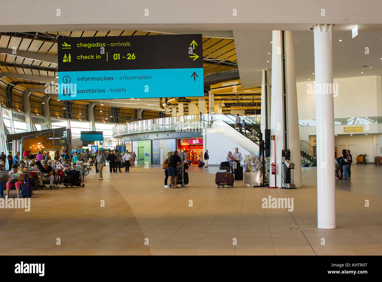 Travelers in the refurbished and modernised check in area and shopping concourse of Faro Airport in Portugal Stock Photo