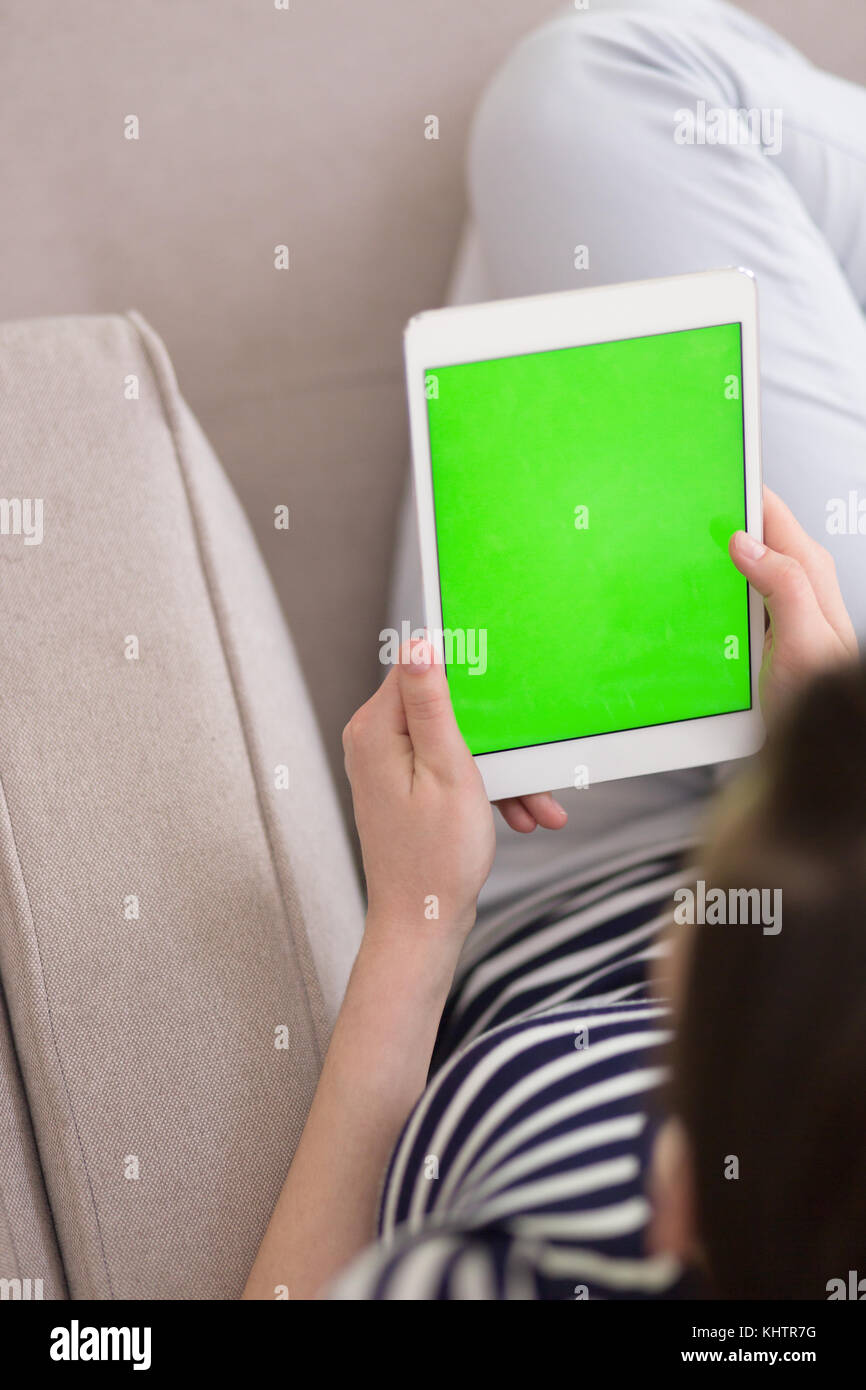 young happy woman on sofa using tablet computer at luxury home Stock ...