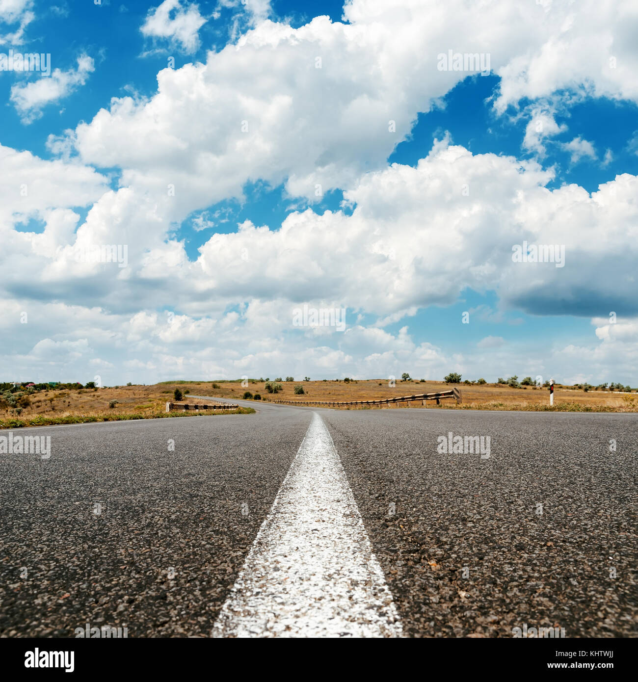 asphalt road to horizon and clouds in blue sky Stock Photo - Alamy