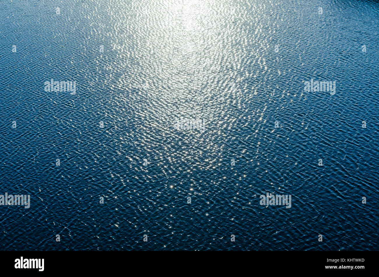 blue water with sun reflections as background Stock Photo - Alamy