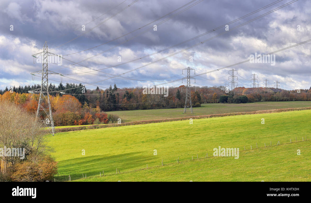 Row of Electricity Pylons in the Chiltern Hills in rural Buckinghamshire in England Stock Photo