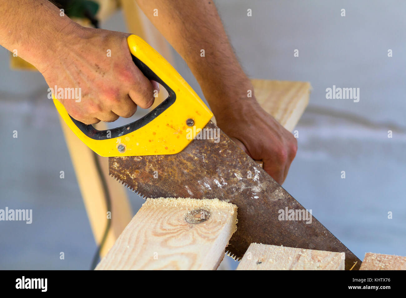 Carpenter hand with saw cutting wooden boards Stock Photo - Alamy