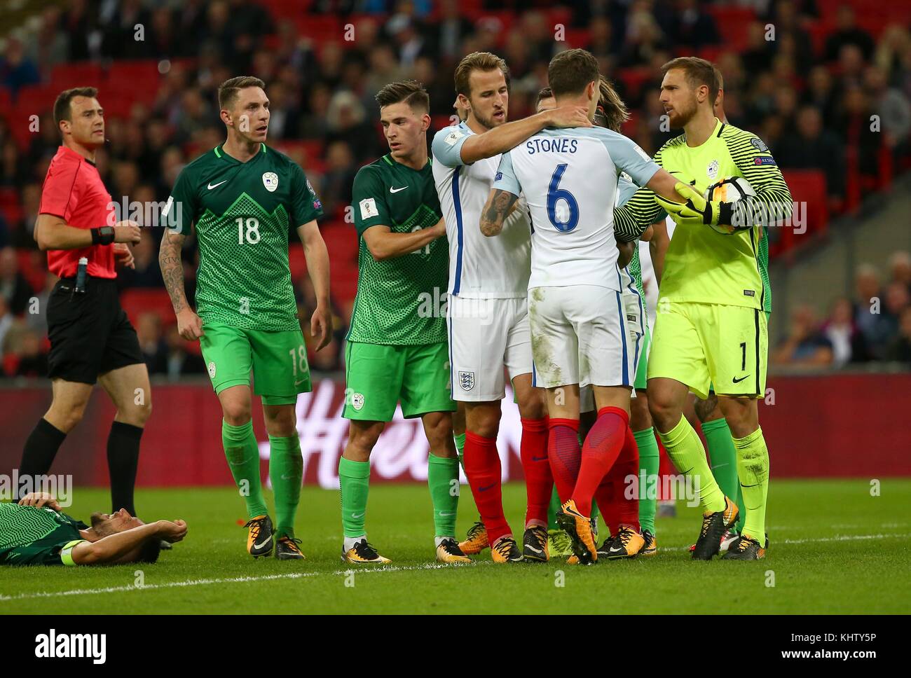 Harry Kane of England pulls John Stones away from an altercation with Rene Krhin of Slovenia  during the FIFA World Cup Qualifier match between England and Slovenia at Wembley Stadium in London. 05 Oct 2017 *** EDITORIAL USE ONLY *** No merchandising. For Football images FA and Premier League restrictions apply inc. no internet/mobile usage without FAPL license - for details contact Football Dataco Stock Photo