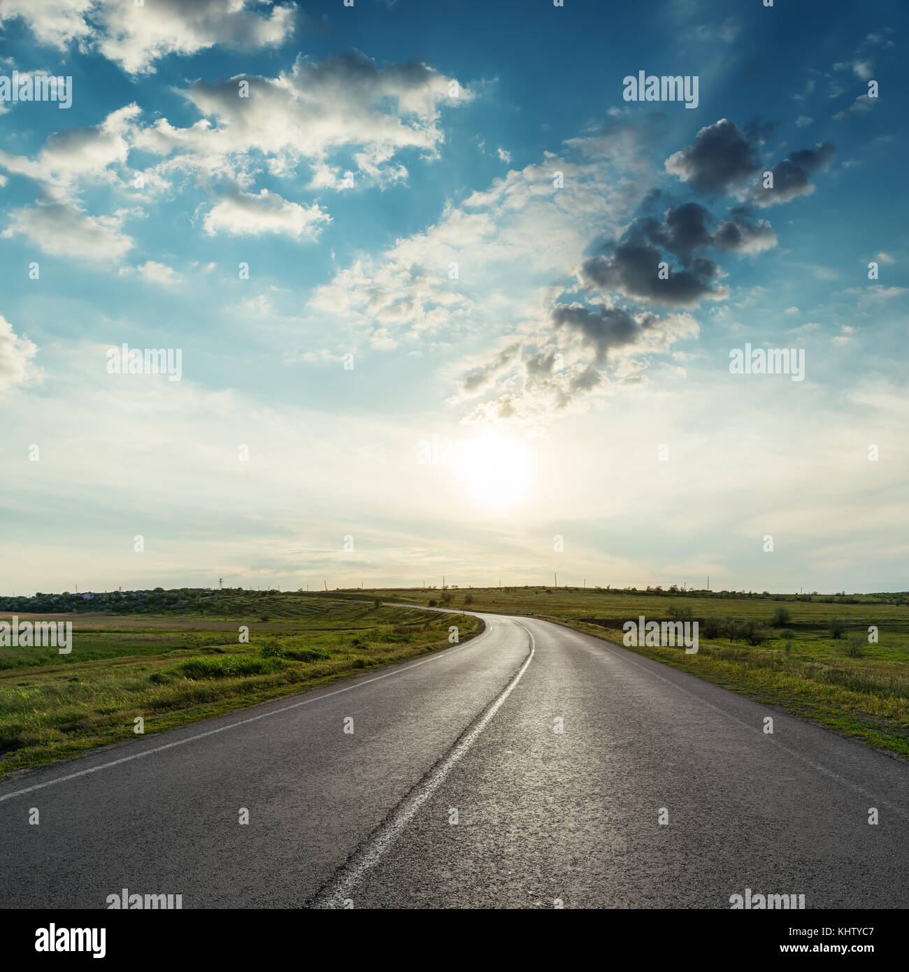 sunset in clouds over asphalt road Stock Photo - Alamy