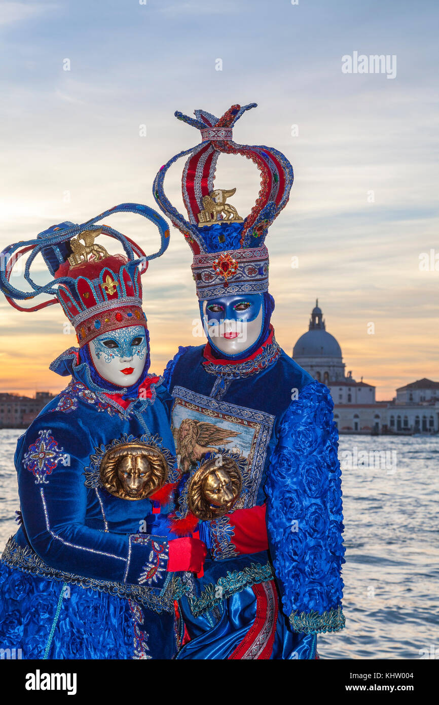 Venice, Carnival, 2017, Veneto, Italy, couple at sunset at the lagoon. Man and woman in traditional costume and mask Stock Photo