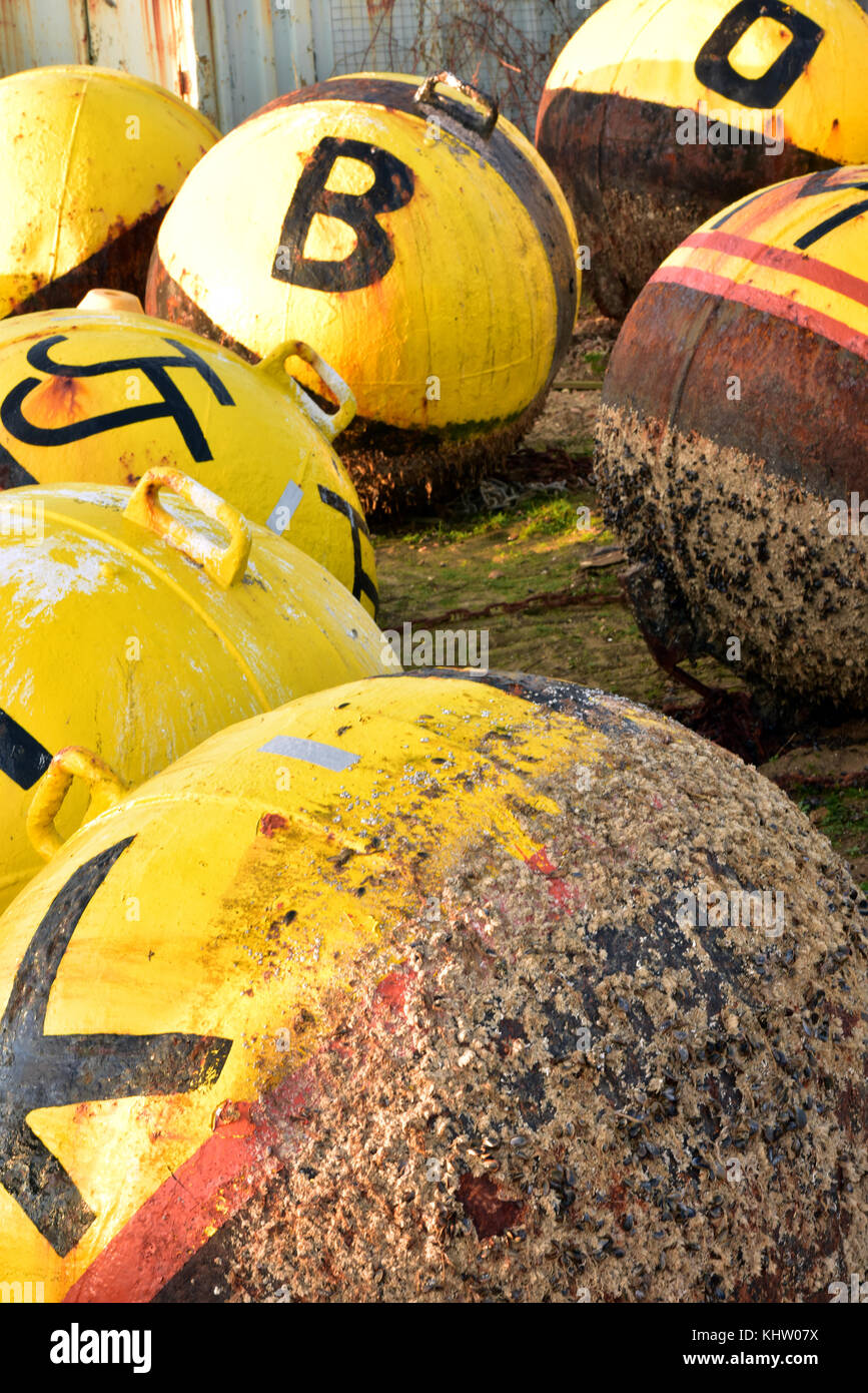 Some channel marker buoys in a boatyard ready for cleaning and re