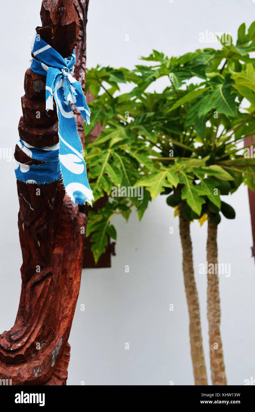 Colorful material tied around carved wood Stock Photo - Alamy