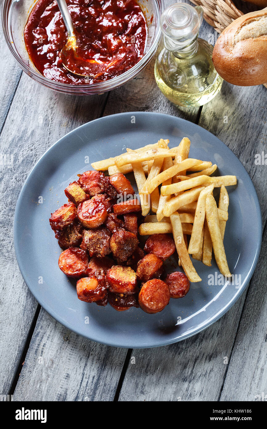 Traditional German currywurst pieces of sausage with curry sauce and