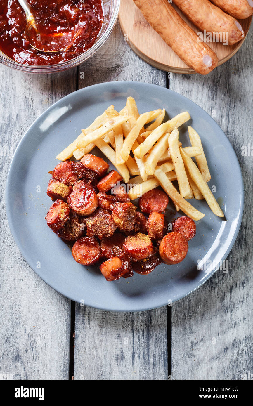 Traditional German currywurst pieces of sausage with curry sauce and