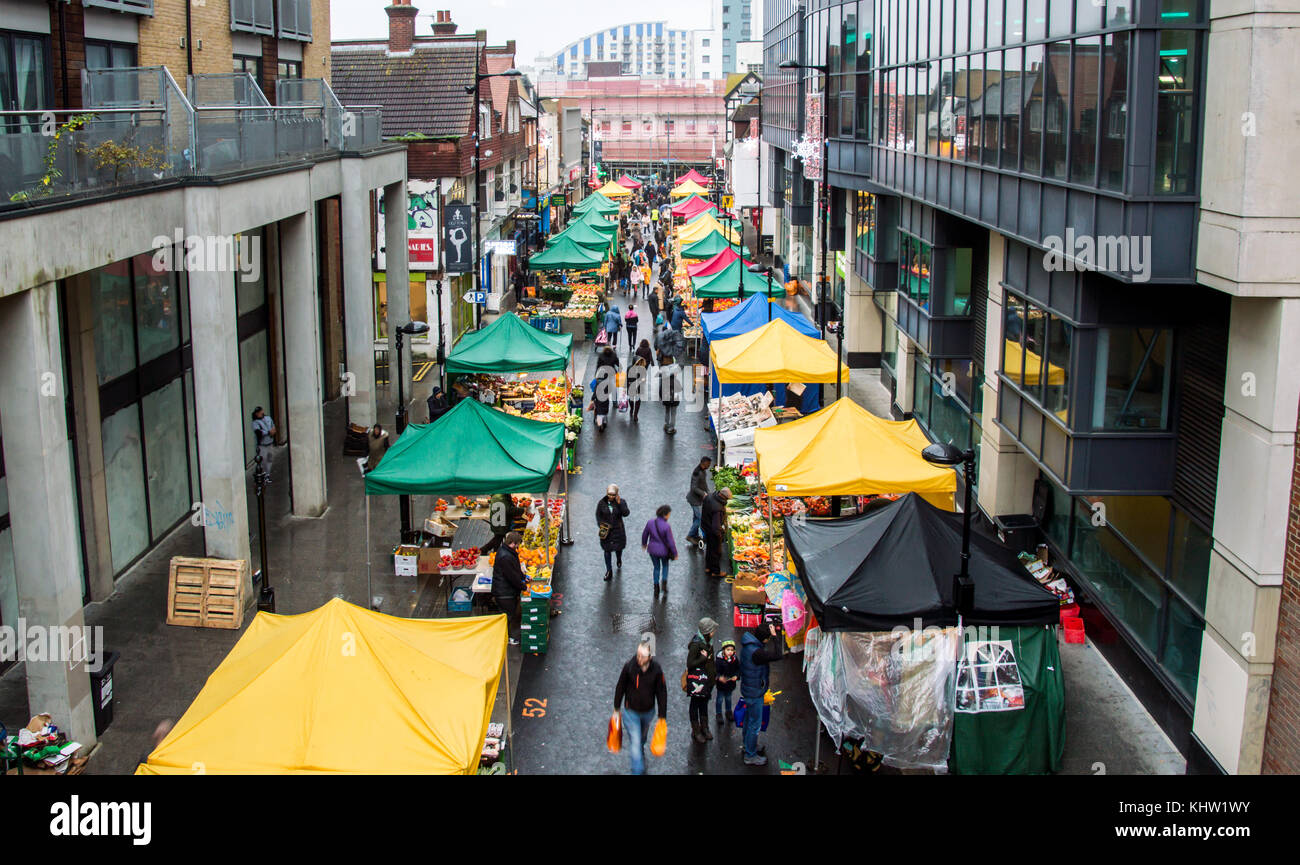 Croydon Surrey street market on a rainy day with sellers selling fruits and vegetables Stock Photo