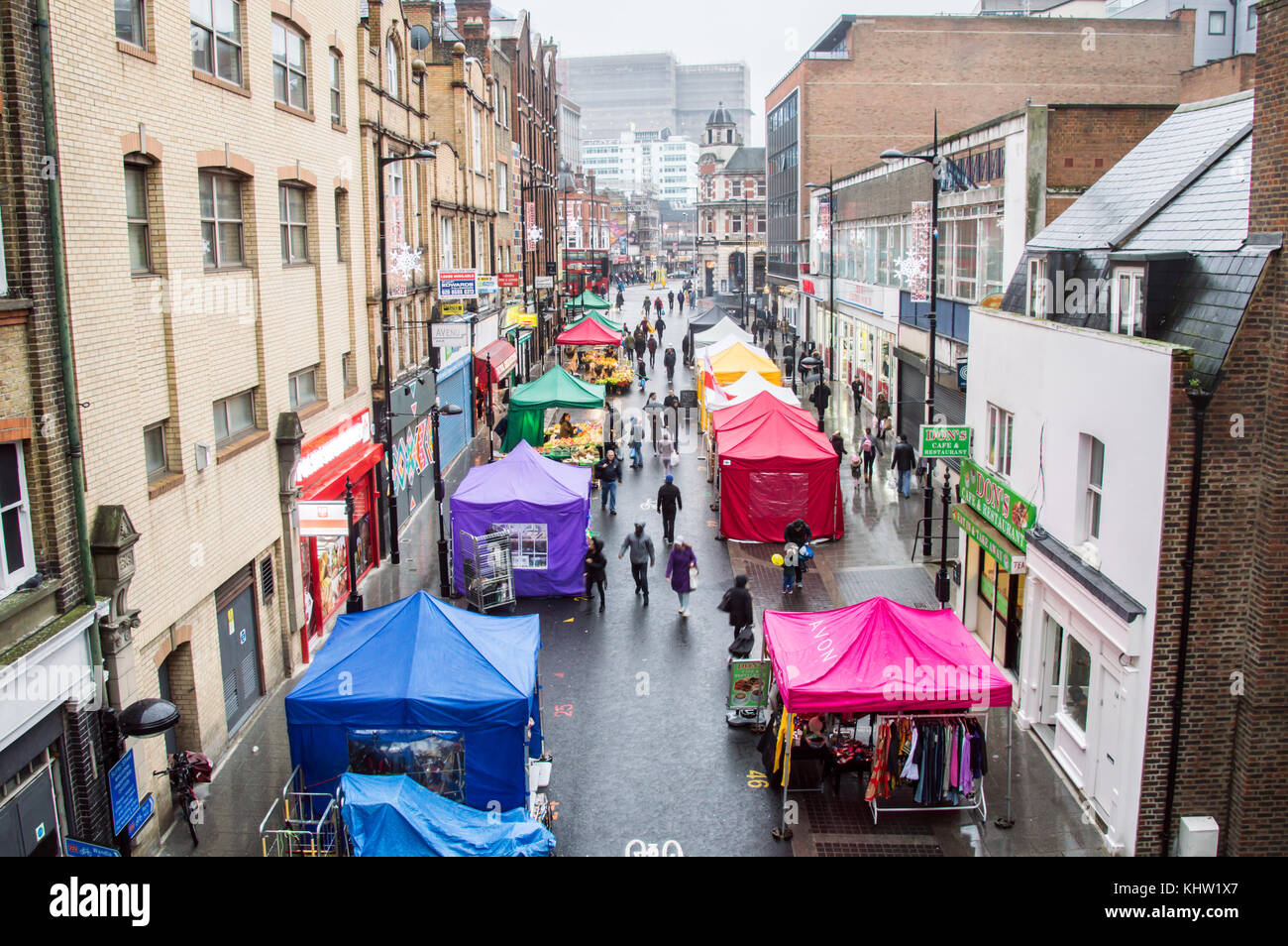 Croydon Surrey street market on a rainy day with sellers selling fruits and vegetables Stock Photo