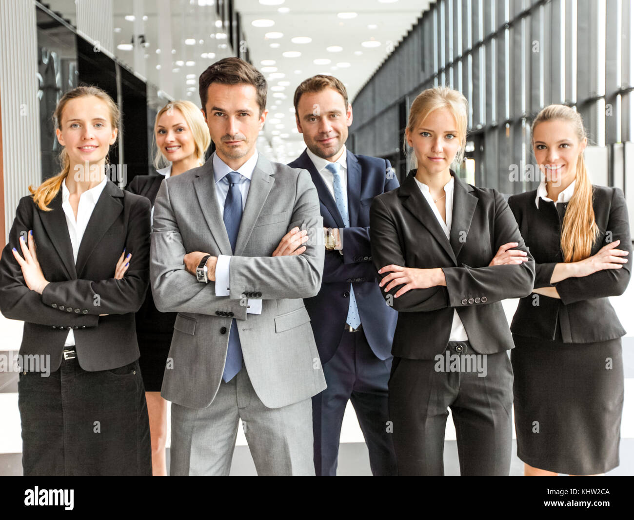 Portrait of successful business people team standing together in modern ...