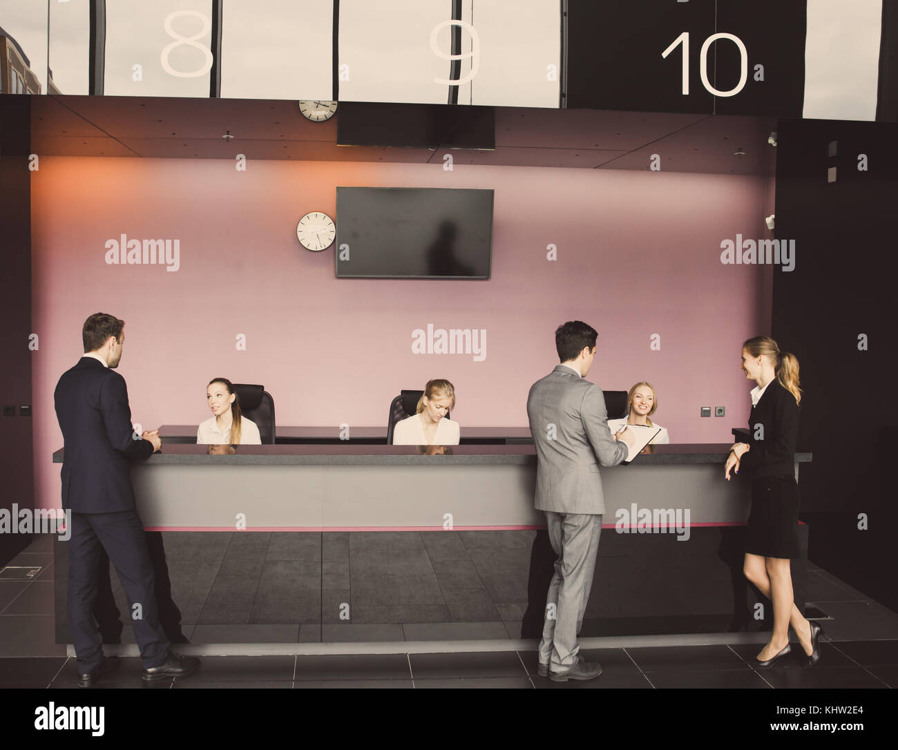 Business People At Reception Or Front Desk In Office Building