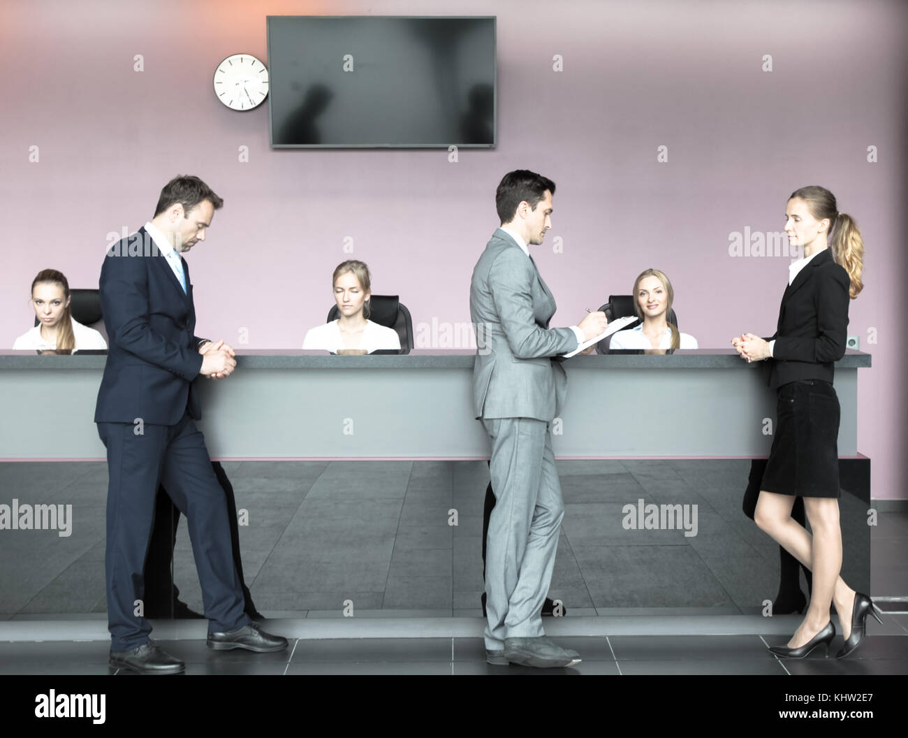 Business People Filling Forms At Reception Front Desk Stock Photo