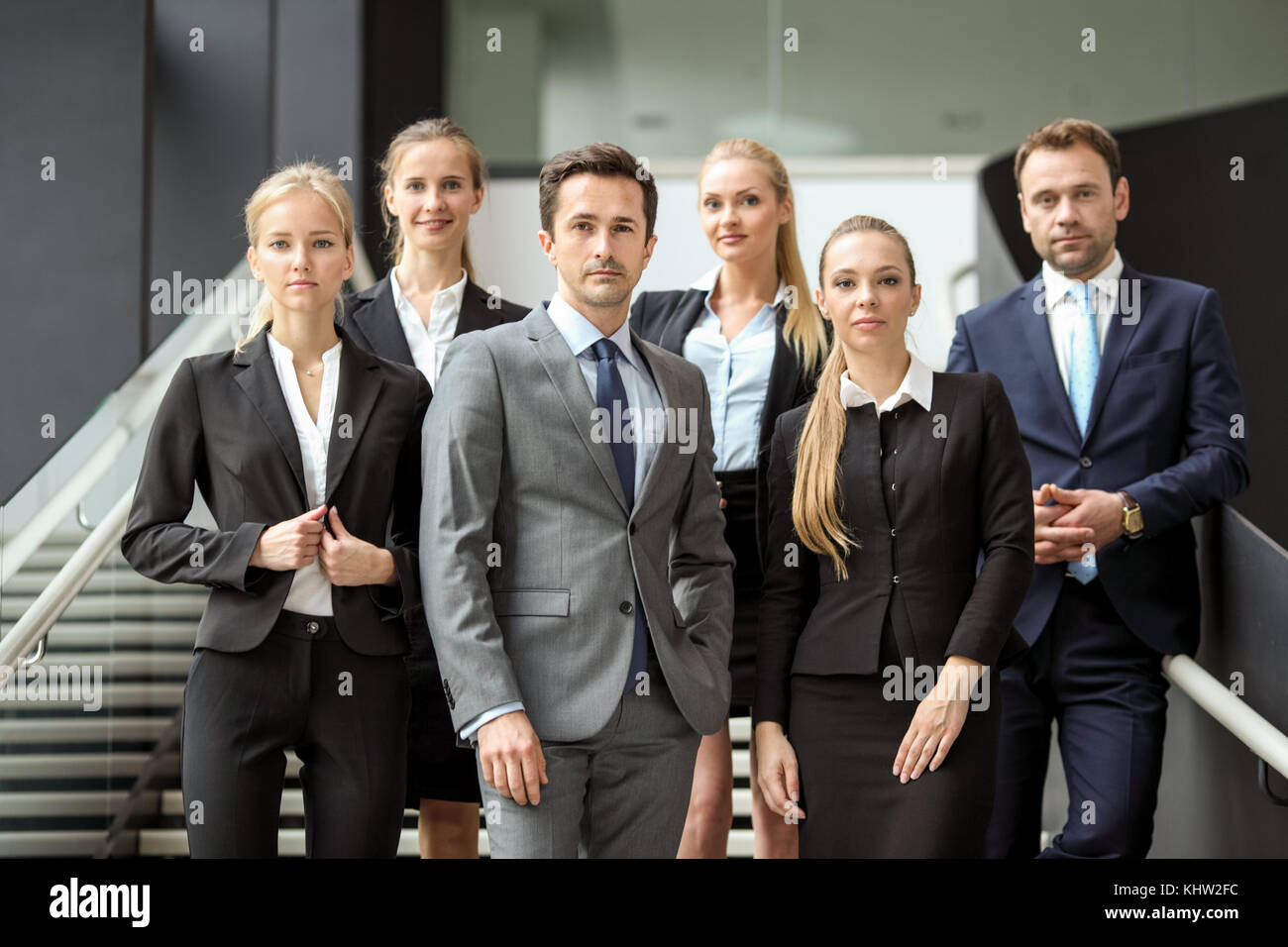 Portrait of successful business people team standing together in modern ...