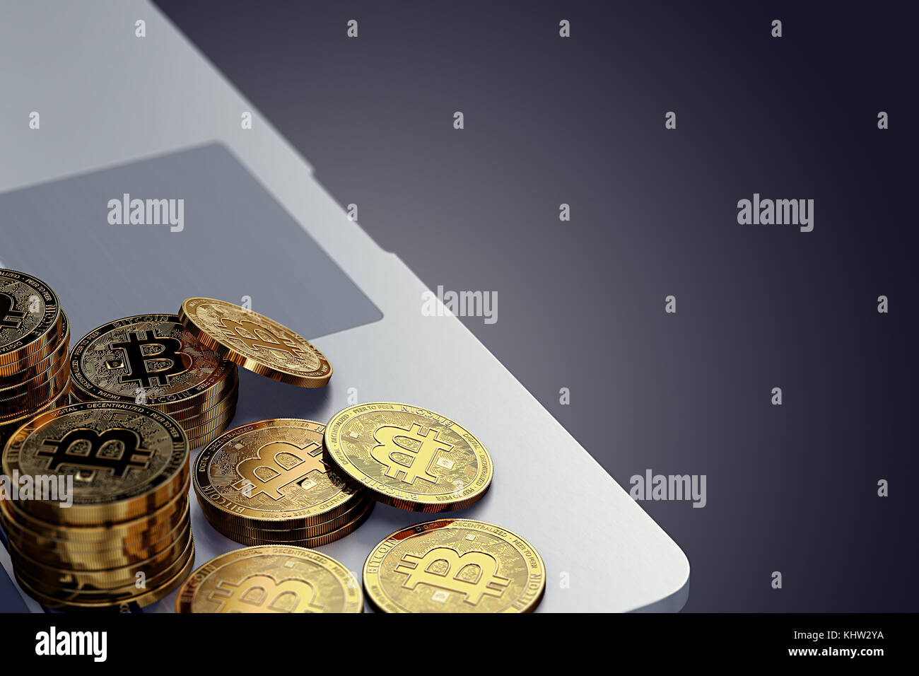 Bitcoin coins laying on the laptop keyboard against dark background ...
