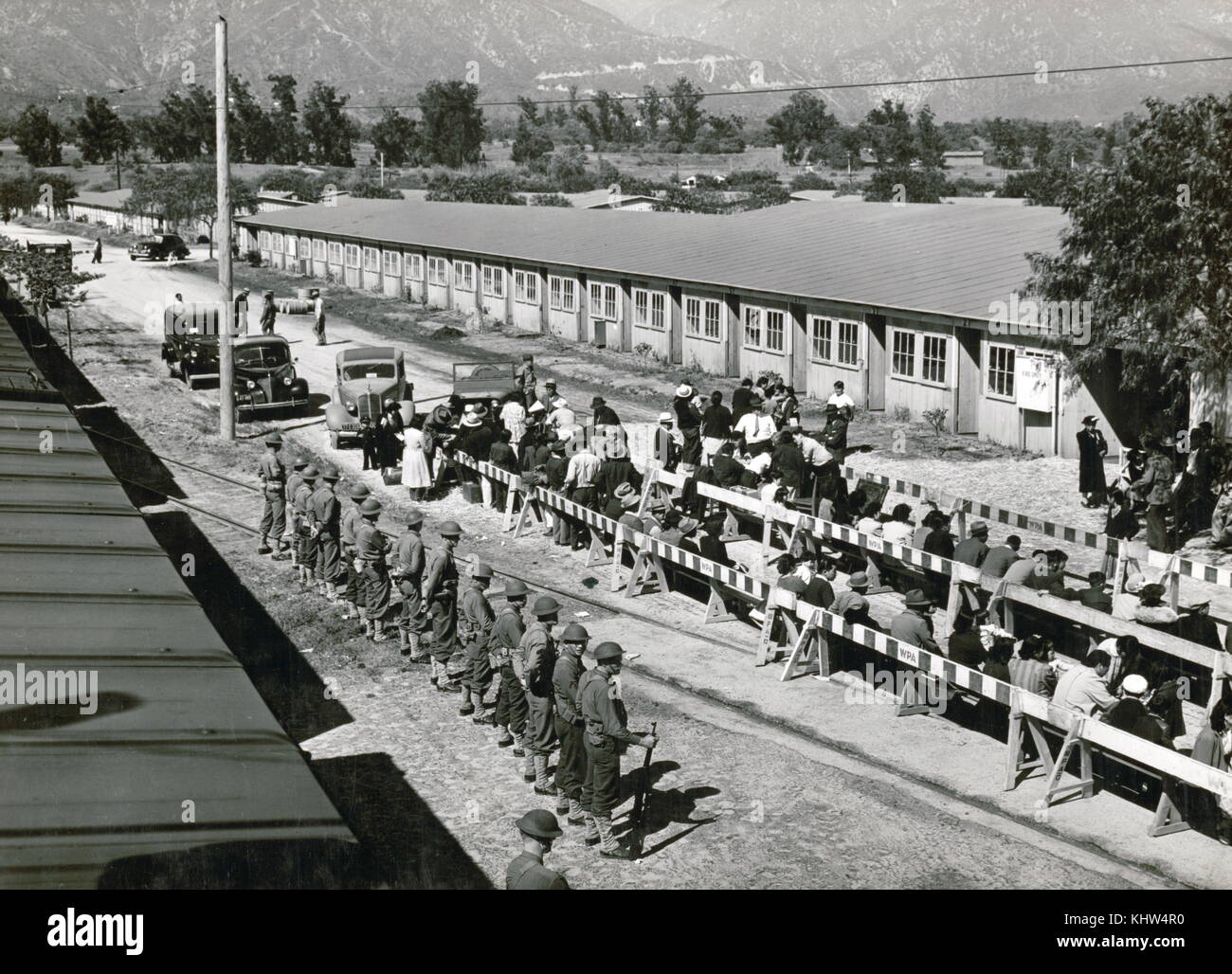 Photograph of the evacuation of Japanese-Americans from the West Coast areas under the U.S. Army War Emergency Order. Japanese people await for registration at the Santa Anita reception centre. Dated 20th Century Stock Photo