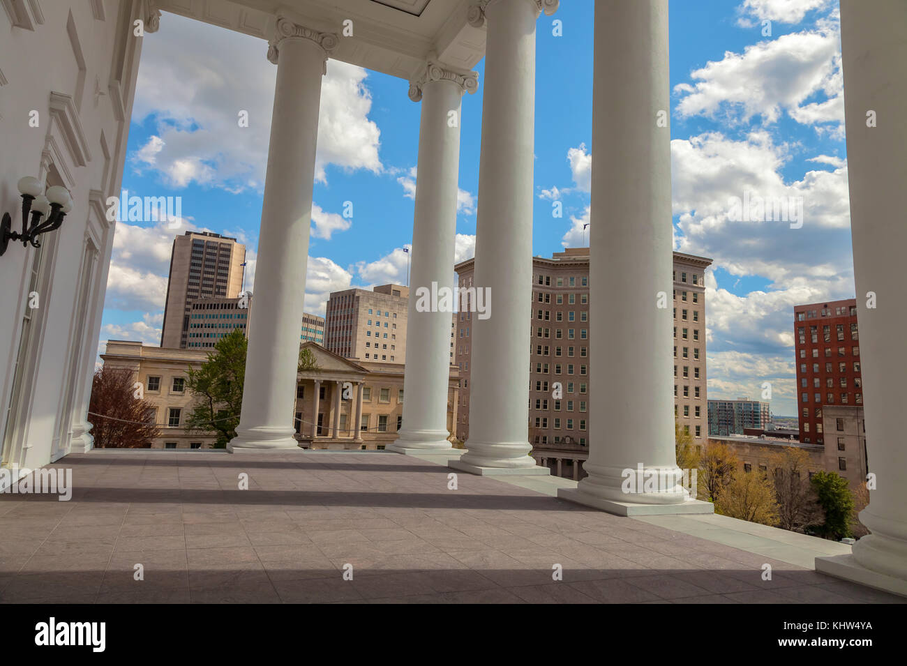 Column structures of the Virginia State Capitol Building with the view of Richmond city high rises in background, United States. Stock Photo