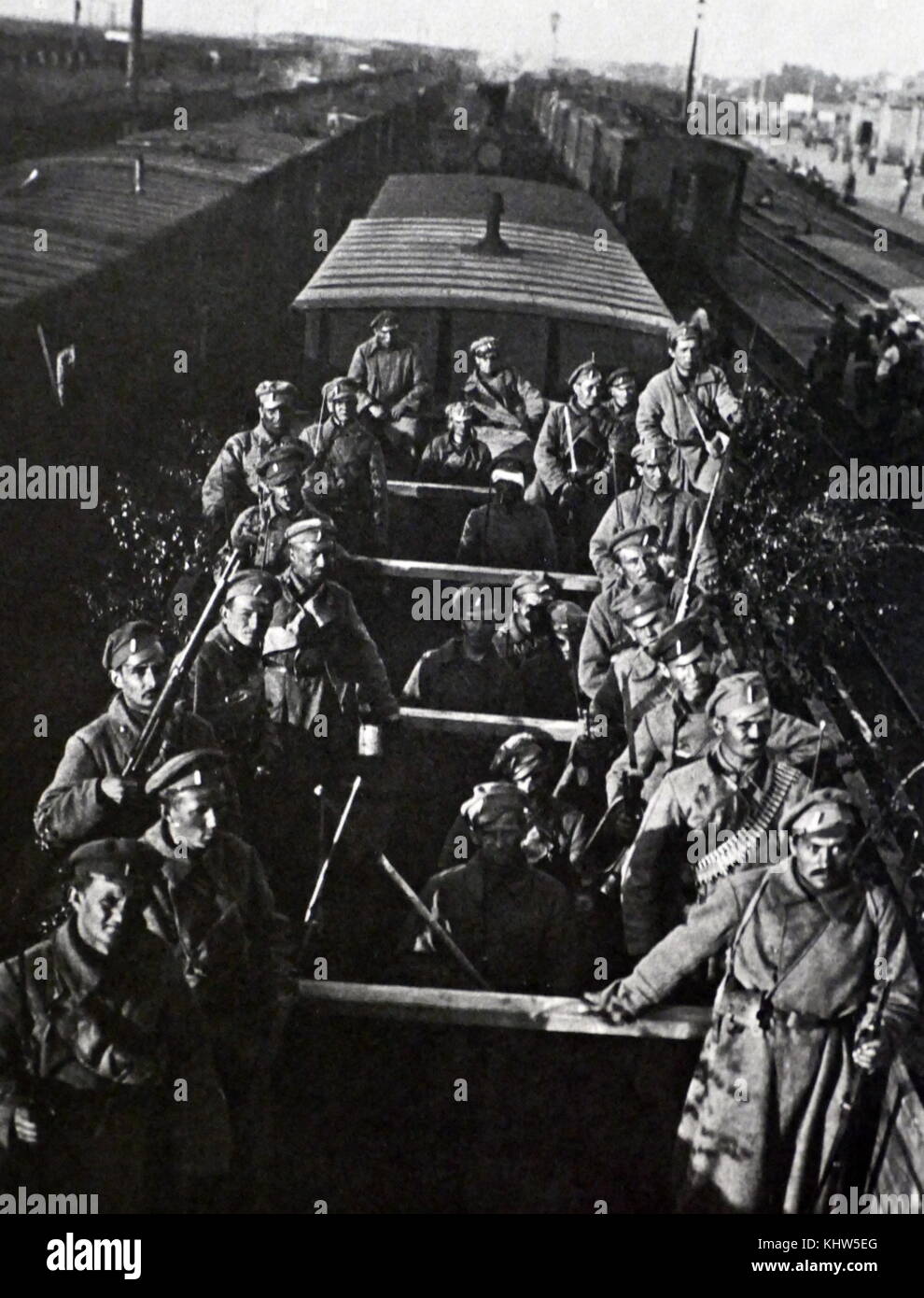 Photograph of the determined soldiers of the Czech Legion in open boxcars, partly camouflaged with branches, as they begin their epic journey on the Trans-Siberian Railroad. The hoped to fight against Germany in France. Dated 20th Century Stock Photo