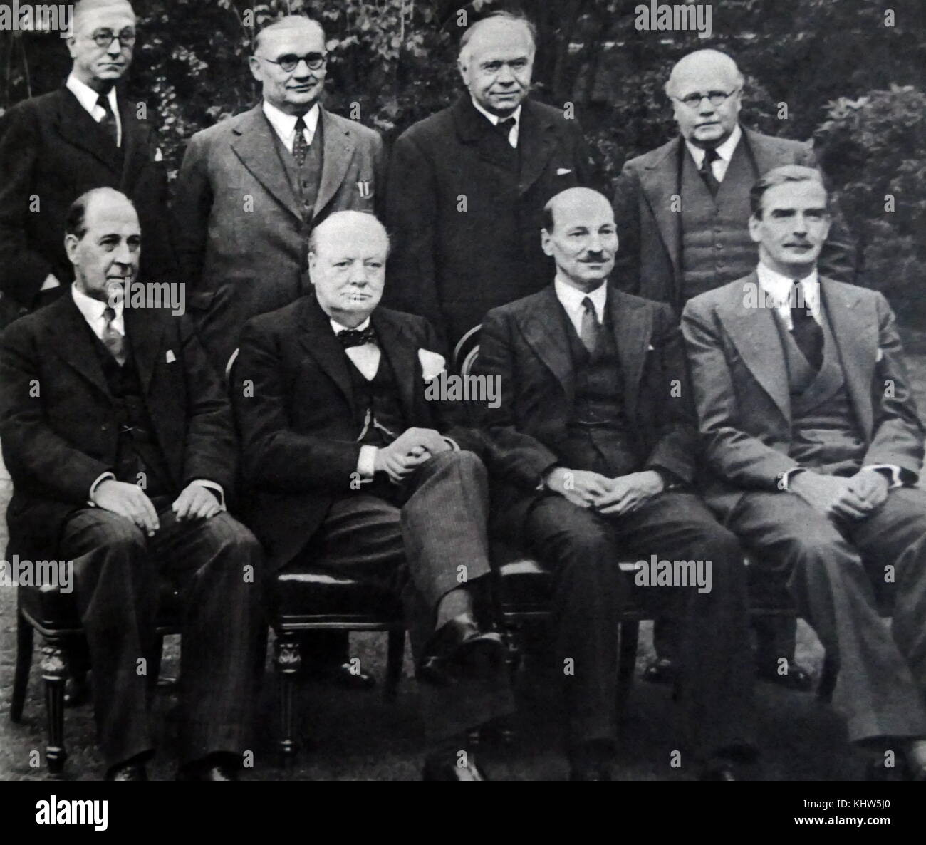 Photograph of Sir Winston Churchill sitting alongside other members of his War Cabinet. (Back row: left to right) Mr Arthur Greenwood (1880-1954) Deputy Leader of the Labour Party; Mr Ernest Bevin (1881-1951) Minister of Labour; Max Aitken, 1st Baron Beaverbrook (1879-1964) Minister of Aircraft Production; Sir Kingsley Wood (1881-1943) Chancellor of the Exchequer. (Front row: left to right) John Anderson, 1st Viscount Waverley (1882-1958) Lord President of the Council; Sir Winston Churchill (1874-1965) Prime Minister of the United Kingdom; Clement Attlee (1883-1967) Lord Privy Seal. Stock Photo