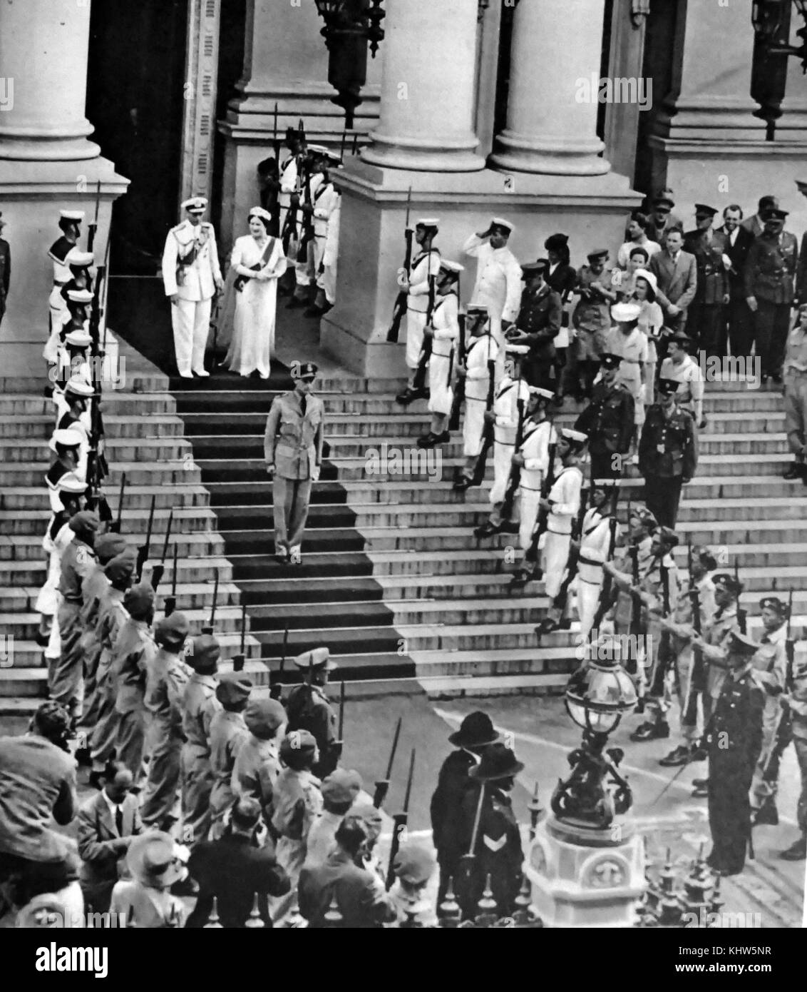 Photograph of King George VI and Queen Elizabeth Queen Mother leaving the Parliament House in South Africa after opening the session, speaking in both English and Afrikaans. George VI (1895-1952) King of the United Kingdom and the Dominions of the British Commonwealth, the last Emperor of India and the first Head of the Commonwealth. Queen Elizabeth The Queen Mother (1900-2002). Dated 20th Century Stock Photo