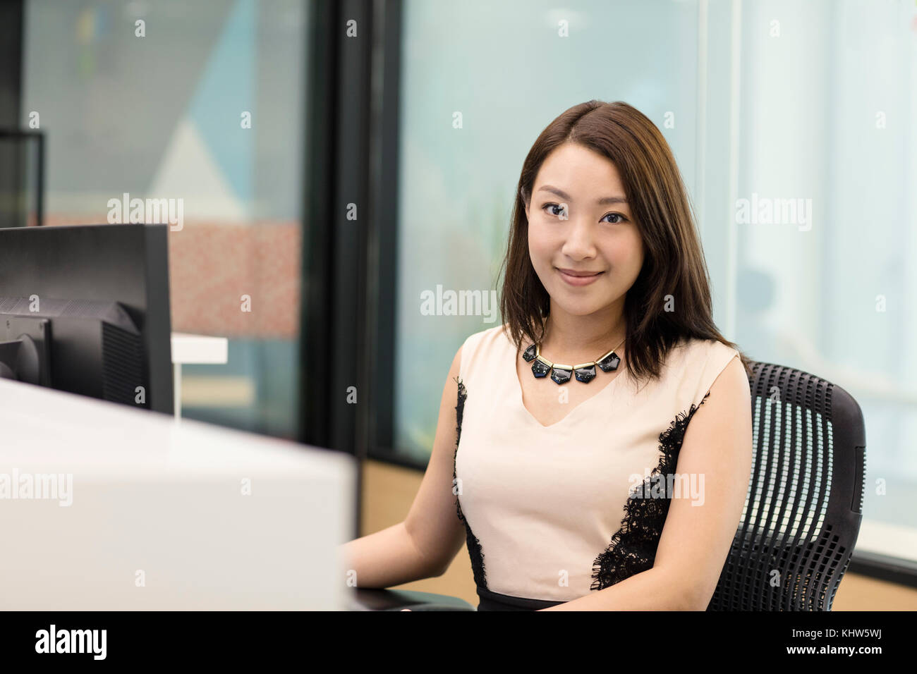 Portrait of business woman looking at camera smiling Stock Photo - Alamy