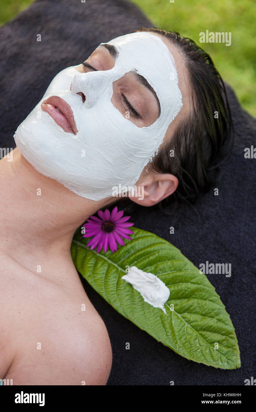 Woman in spa environment, wearing face mask Stock Photo